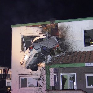 CAR FLIES INTO 2ND STORY OF A BUILDING