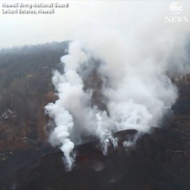 “An aerial view shows the lava flow through Puna, Hawaii, after two new volcanic fissures opened on Saturday, spraying magma into the air.…”