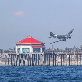 Mark Girardeau on Instagram: “C-47, Willa Dean making a close pass by Huntington Pier at today’s @pacificairshow. Photo taken by @melissasana as we took turns on camera…”