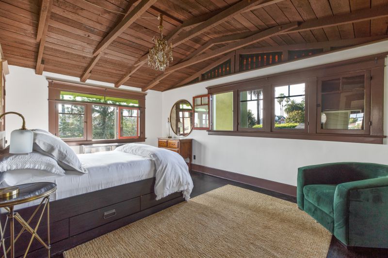 A bedroom with vaulted beam ceilings. 